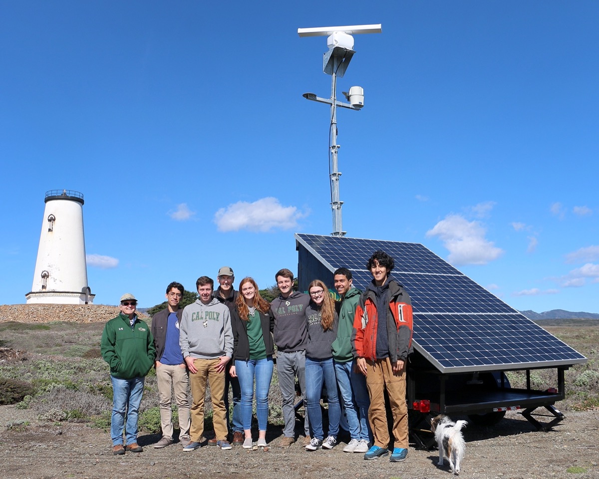 Team at deployment site with lighthouse, Piedras Blancas